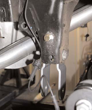 the bottom of the frame. (See Arrow in Photo #30). 48. Loosen the track bar mount bolt on the differential using a 21mm socket. Remove track bar bolt from frame. 49.