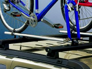 CARRIERS & CARGO HAULING Racks & Carriers - Bicycle Carrier, Roof-Mount Commander 2010 2006 B 17300 Upright Style, Aluminum, lockable, mounts to T-slot compatible rack, fits all bike styles Compass