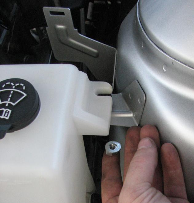 Figure 15: Tip for easily threading the nut onto the bolt 25. Plug in the washer extension to the harness. 26.