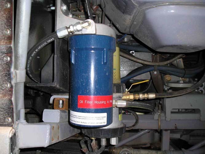system parts and the existing diesel fuel filter. The mechanics unbolted the diesel fuel filter, installed the bracket, and then attached the diesel fuel filter to the bracket.