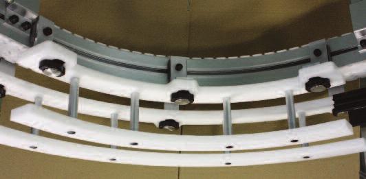 with wheels. Figure 2: 2 pairs of quick dismantling ROTOBLOC curved guides adapted to each side of a conveyor.