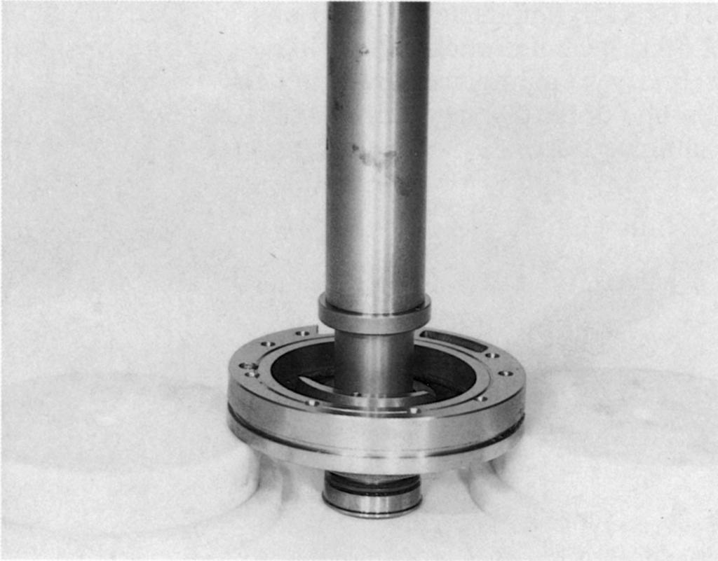 Press out sealing ring and needle bearing under mandrel press.