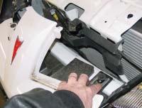 Go through the headlight cavity and remove two nuts from the fender, fascia junction on each