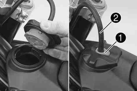 6Opening the filler cap Press release button, turn the filler cap counterclockwise and lift it free. 400199-10 5.