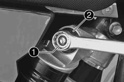 MAINTENANCE WORK ON CHASSIS AND ENGINE 27 Turn adjusting screw all the way clockwise with a ring wrench. Do not loosen nut!