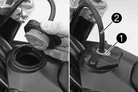7Opening filler cap Press release button, turn filler cap counterclockwise and lift it upwards and remove. 400199-10 5.