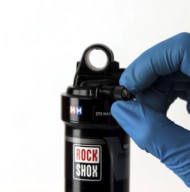 Spray isopropyl alcohol on the entire shock and wipe it with a clean rag.