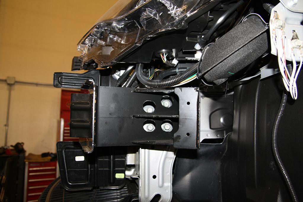 On the driver's side only, remove four 14mm (head) bolts attaching the extra framing to the bumper core (Fig.B).
