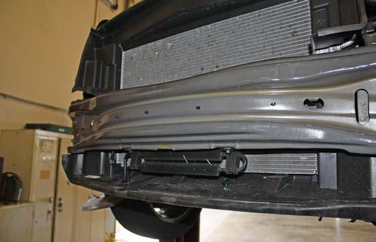 Remove the wiring loom from the back of the bumper core by releasing five plastic fasteners on the front (Fig.