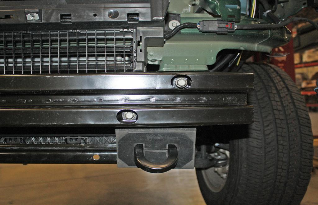 Retain the tow hooks and their hardware for replacement in case the bracket