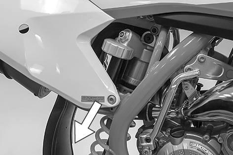 Push the swingarm back and secure it against falling over.