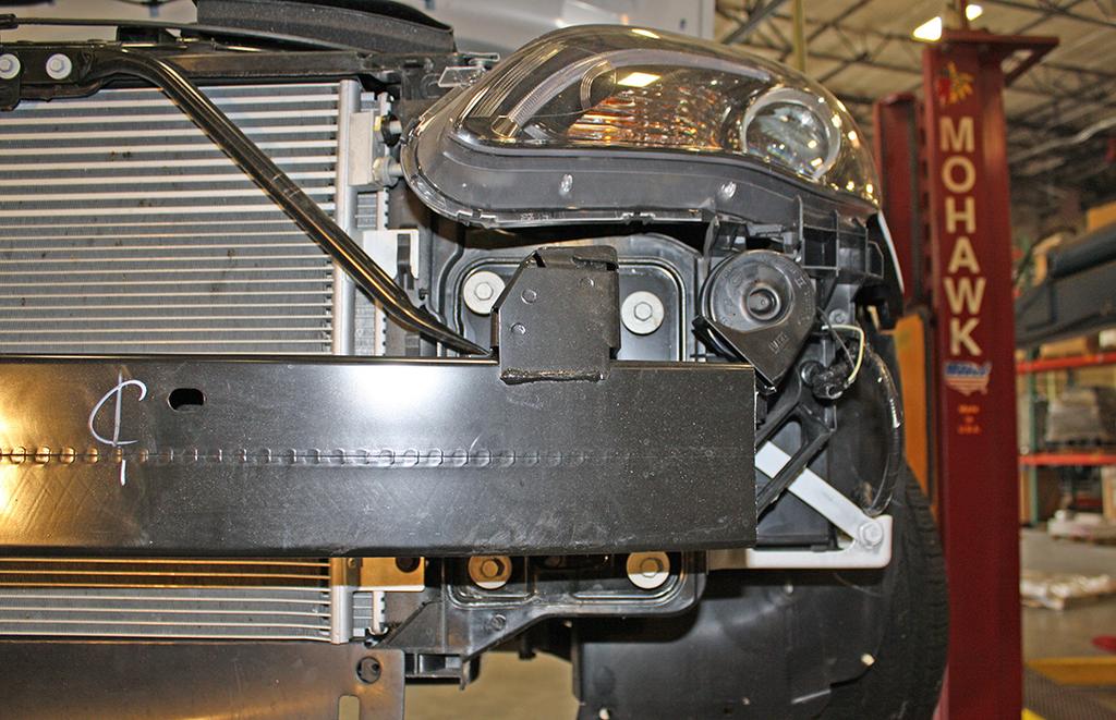 four 13mm (head) bolts attaching the bumper core to the frame (Fig.I).
