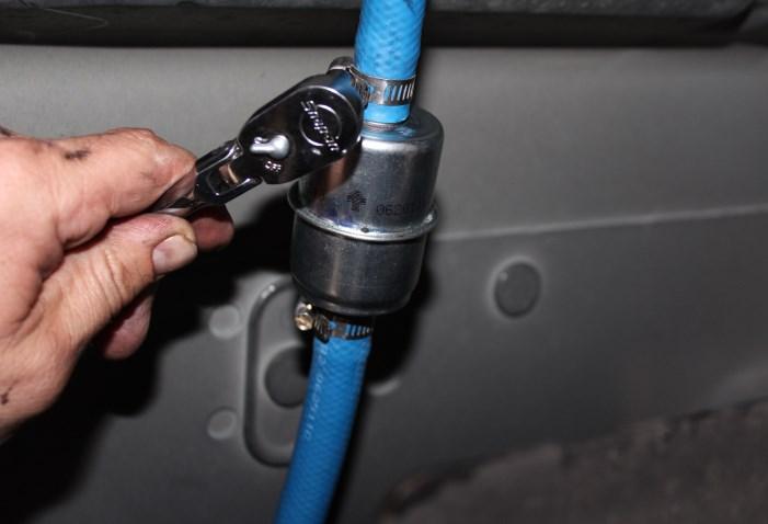 B. Install in-line fuel filter in an accessible location in the suction line using the HC-1001 s.