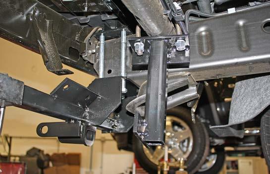 On each side, place the rear brace below the crossmember and place the U bolt around the crossmember, and bolt through the rear