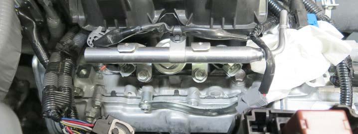 Using a 10mm socket, remove the EVAP line support bracket from the driver side manifold. 29.