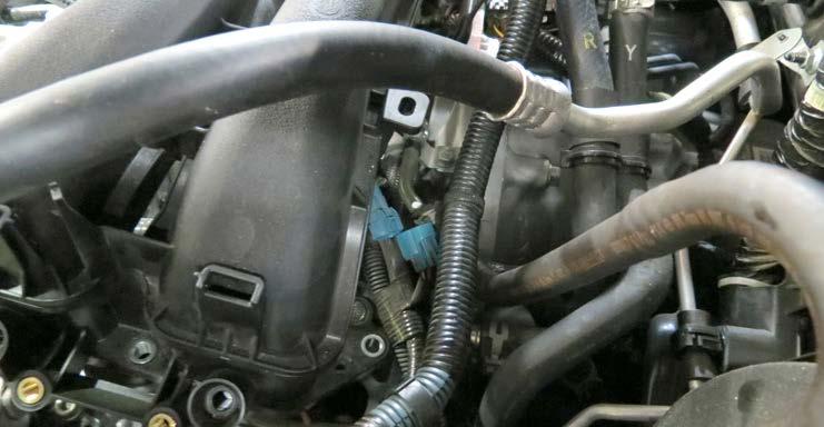 47. Carefully tilt the manifold forward and unplug the blue EVAP connector from the EVAP extension harness behind the driver side manifold runner. 51.