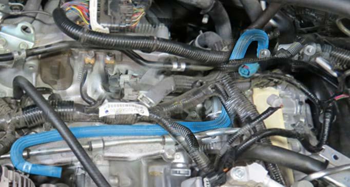 Using long needle nose pliers, remove the throttle body outlet