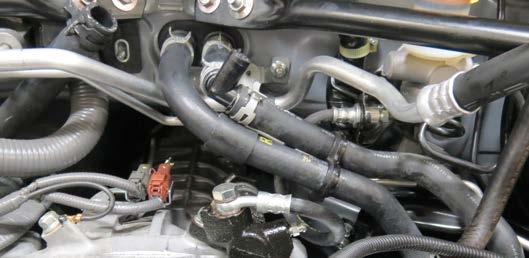 Reposition the protective sleeve to where the driver side hose clamp contacts the passenger side