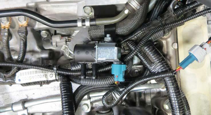 Position the supplied EVAP bracket under the brake booster line and secure the EVAP bracket