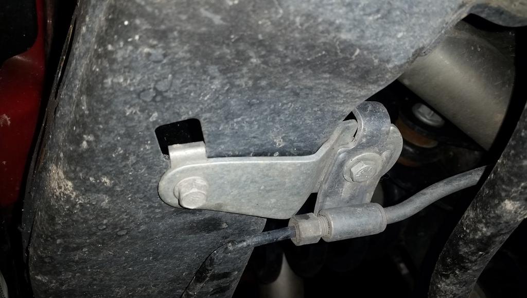 15 With both factory links removed, install the swivel end of the link into the sway bar from the outside. Install the new lock nut using the 19mm end wrench and a 6mm allen wrench.