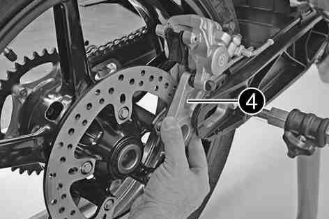 MAINTENANCE WORK ON CHASSIS AND ENGINE 88 Pull the rear wheel and brake caliper support together to the rear until you can swing the brake caliper support to the side.