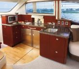 Elegant features include wood flooring, fully adjustable thigh-rise helm seating, master and port staterooms with flatscreen TVs, and two full head compartments with