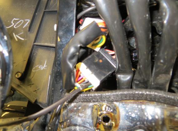 Locate the 12-Pin connector on the OEM wiring harness. This connector is located on the inside of the right (sitting on bike) fairing support bracket, below the radio.