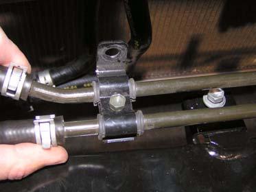 Install power steering cooler line onto bumper crush support with two bolts.