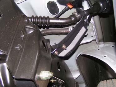 Move parking brake cable from underneath heat shield towards driver side.
