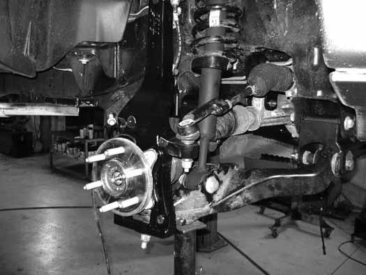 58. Install tie rod from top-down. Torque to 111 ft-lbs. 59. Install the brake rotor and caliper to the knuckle with OE bolts. Torque to 148 ft-lbs. 60.