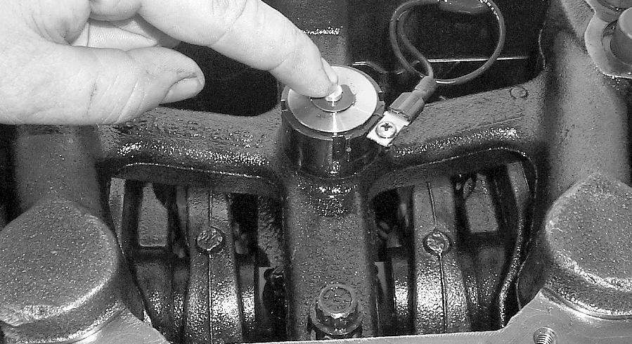 Allow engine to idle for a couple of minutes, depress the armature on each solenoid one at a time until the air is purged from the housings.