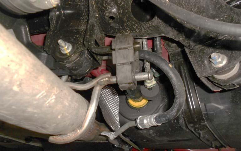10. Loosen the 15mm nut from the right side exhaust flange connected to the