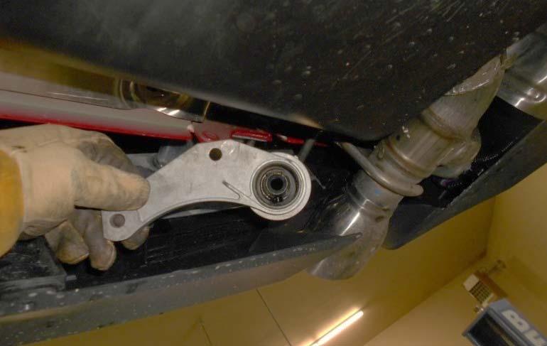 Remove the forward rubber isolators from the exhaust system on the left and