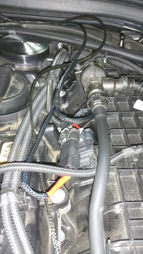 7. Referring to the photo below, locate the pressure sensor installed on the intake manifold, near the center-top of the engine.