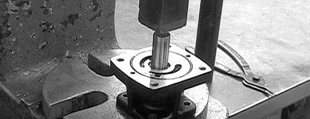 If bearing is binding against the retaining ring so that it cannot easily be removed, place the motor body (threaded portion of the shaft up) on arbor press.