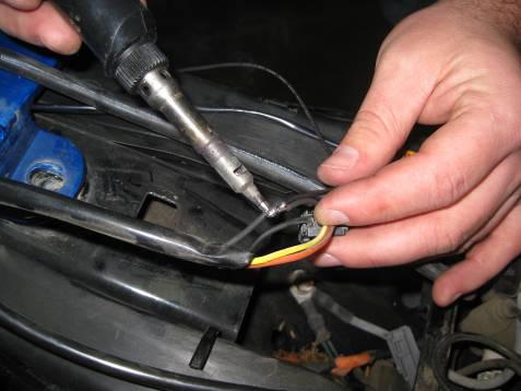 Soldering and covering with heat shrink is the preferred method for attaching the ground wire but a properly used butt connector will also work.