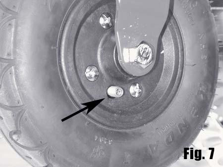 1. Remove the valve stem cover and expose the valve stem (Fig. 7). 2. Using a standard bicycle pump, inflate the tires to 50 PSI and replace the valve stem cover.