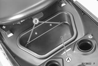 To close the lid, push the knob until it latches. j A. Rear Storage Case B. Drain Plugs A.