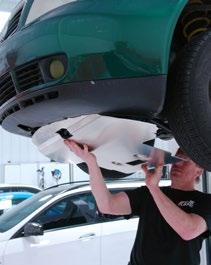 Step 14: Guide the front of the skid plate into place above the lower lip of the bumper cover, then