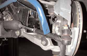 Make sure the passenger s side of the bar falls behind the tie rod.