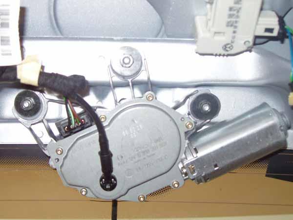 perspective of a closed hatch). Now you have access to the wiper motor.