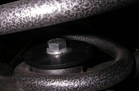Install the new rear coil spring retainers on the bottom end of the coil springs.