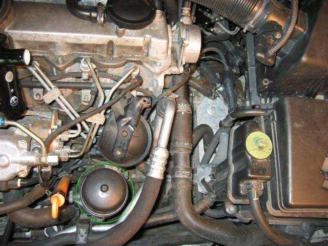 The oil filter housing is the one with the green circle.