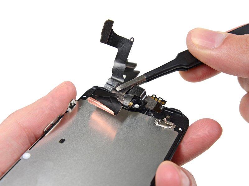 Carefully peel the cable assembly off of the LCD shield plate to remove it from the
