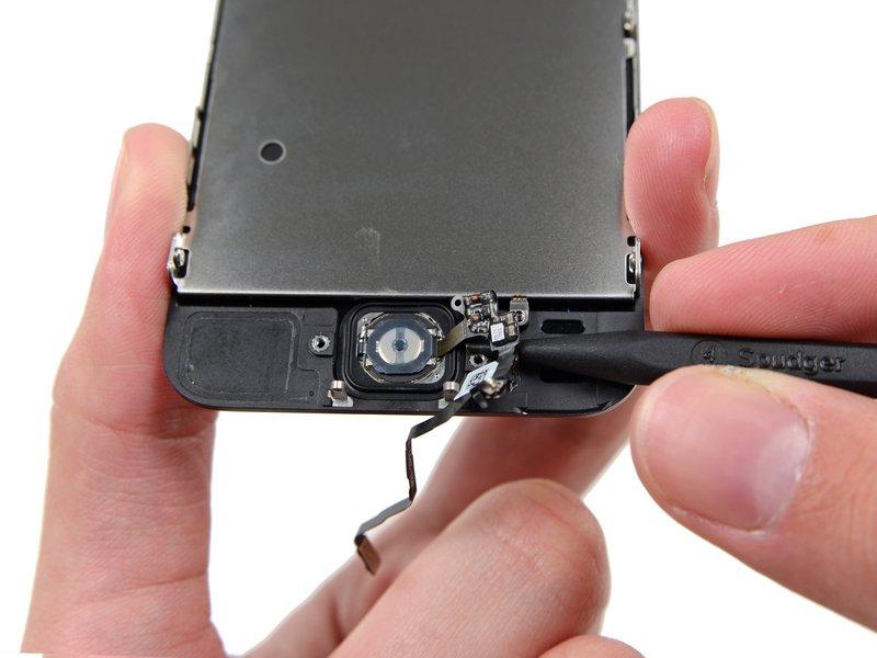 Gently work the spudger underneath the cable to separate the home button cable from the front