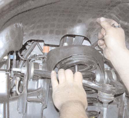 Disconnect the Upper A-Arm ball joint from the top of the steering knuckle using a 21mm