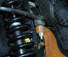 With the vehicle on flat level ground, set the emergency brake & block the rear tires. Place a floor jack under the lower control arm s front cross member & raise the vehicle.