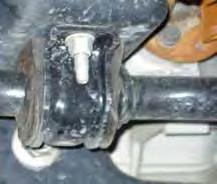 Remove the brake caliper using a 13mm wrench. (See Photo # 1) It will not be necessary to remove the brake line from the brake caliper. Simply wire it out of the way until reassembly.