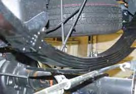 26. Install the new Skyjacker rear leaf spring on top of the OEM block.