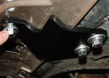 19. Remove two lower subframe bolts on each side and bolt the lower braces in place using the supplied 12mm x 1.25 x 50mm bolts and ½" spacers.